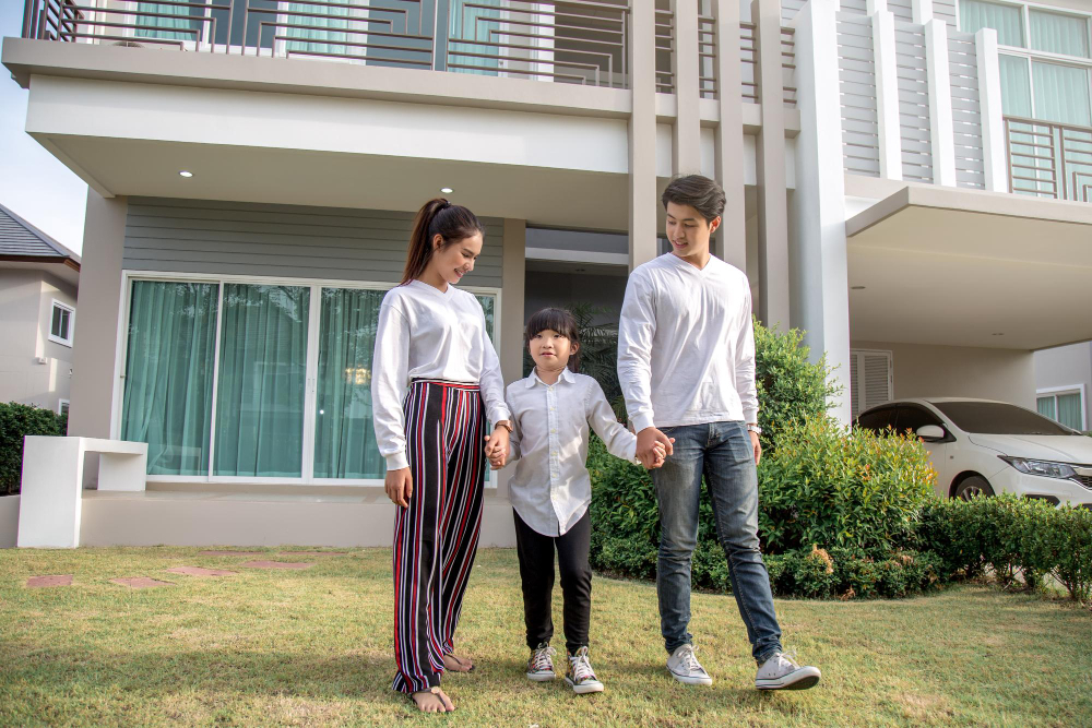 A happy family outside their modern home