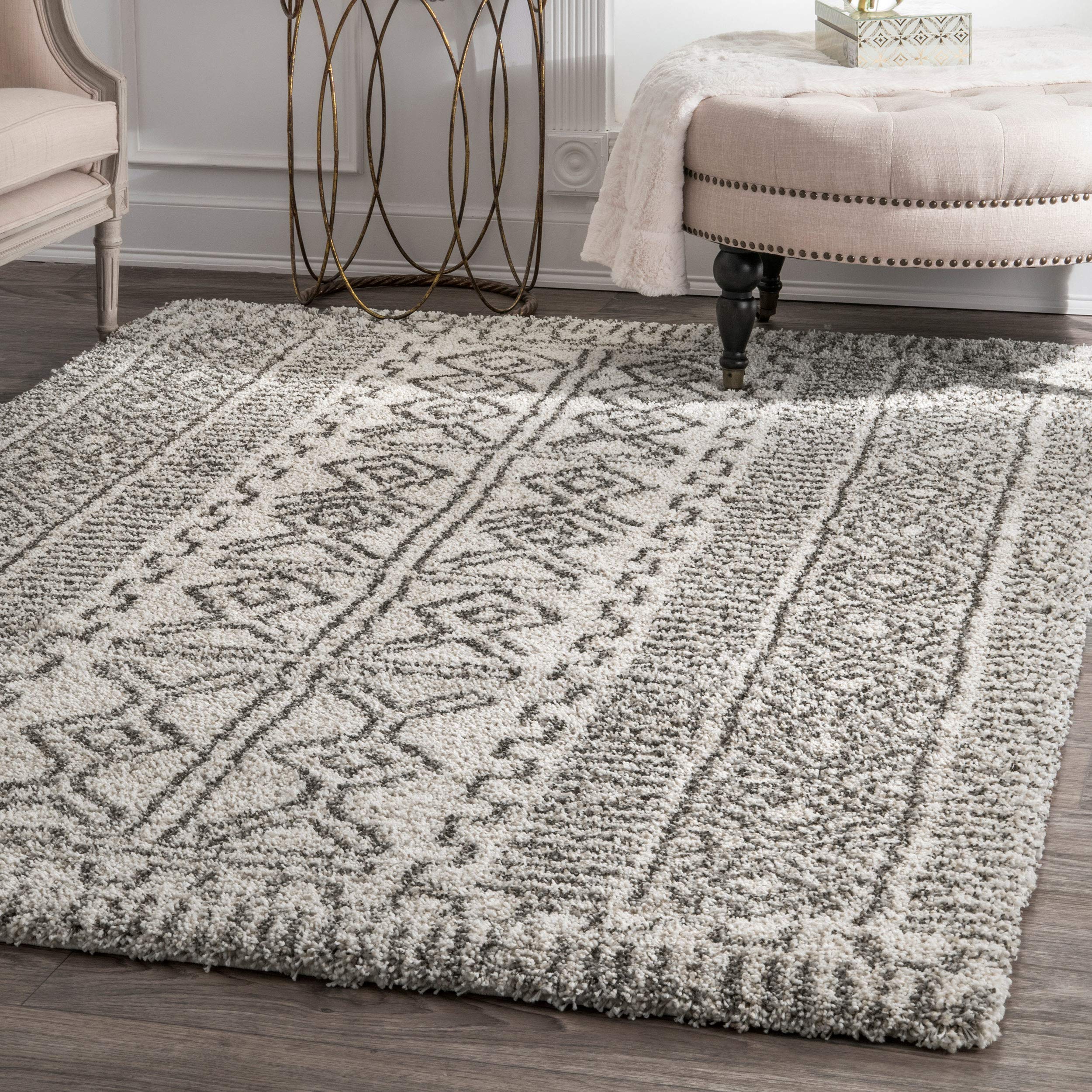 Modern 4x6 area rug placed under a coffee table in a small living room